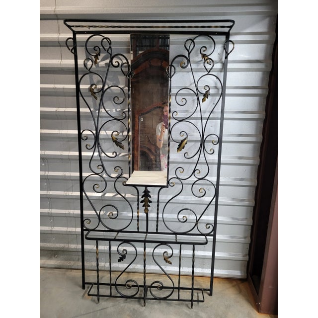 This is an authentic French iron coat rack from the 1950’s. This piece features lots of scrollwork with several areas for...