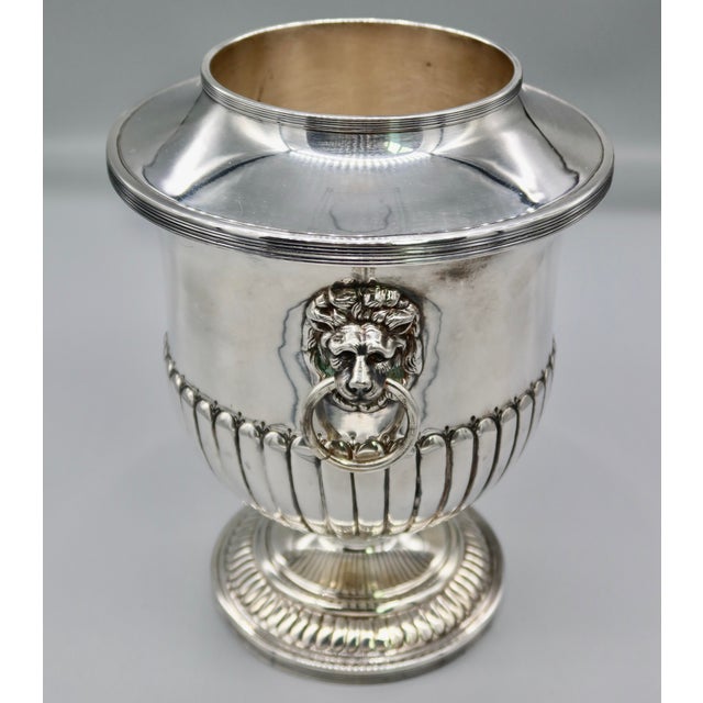 A beautifully crafted English silver plate champagne bucket in the classic Regency style — half-reeded body, decorative...