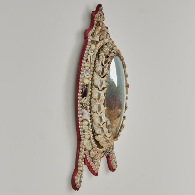 Enchanting 19th century sailors valentine having a rare form hand decorated with exotic seashells, around an image of a...