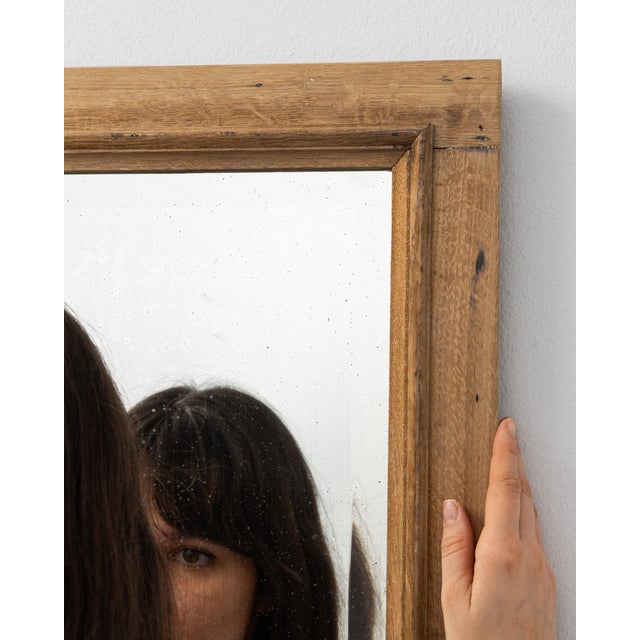 This piece presents as a mirror, distinguished by natural honey wood frame, rectangular. The piece dates to 19th Century,...