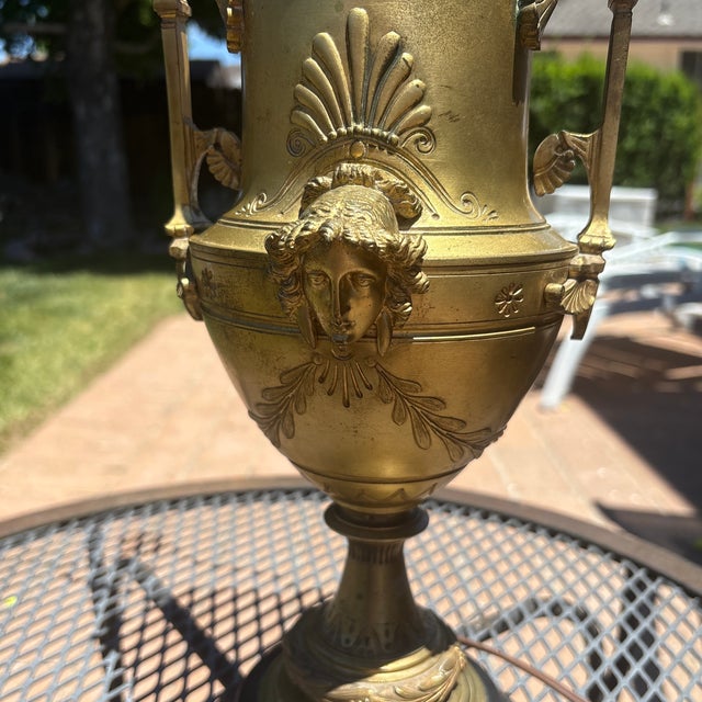 Antique French gilt-bronze table lamp, of twin-handled urn form with a mask in hight relief to either side in Neo-...