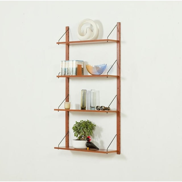 A minimalist, mid-century shelving unit in teak comes from denmark and is dated to the 1970s. overall set dimensions are...