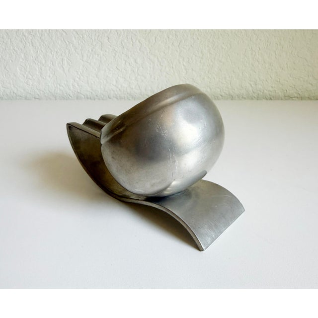 A very handsome Art Deco machine age ashtray by Banka Tinwerk. Produced in Indonesia, circa 1930's. Features a dual...