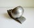 A very handsome Art Deco machine age ashtray by Banka Tinwerk. Produced in Indonesia, circa 1930's. Features a dual...