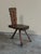 A sculptural chair crafted from wood with a dark finish, Italian craftsmanship from the 1950s. The chair features a flat,...