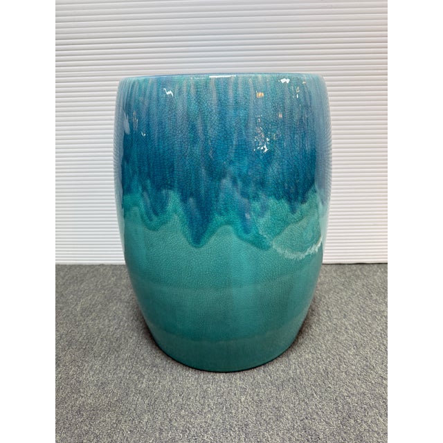 Design Plus Gallery presents a Ceramic Garden Stool with Ombre Glaze. This ceramic stool has a rounded cylindrical form...