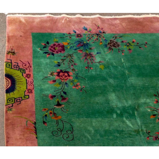 Nichols Chinese Art Deco Pictorial Carpet, with scene of flowers on a green ground with a dusty rose border. 9' 10" L x 7'...