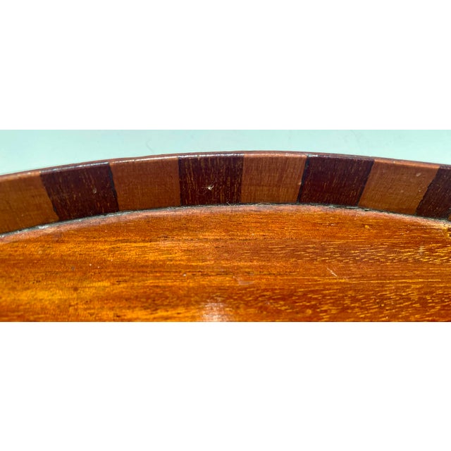 Lovely antique mahogany serving tray. Measures 10” x 14”. Featured shell design in the center and geometric design around...
