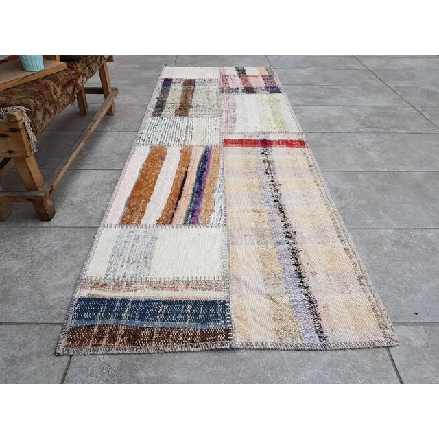 This is a vintage Turkish Oushak rug from the Mid 20th Century. The piece was hand-knotted.