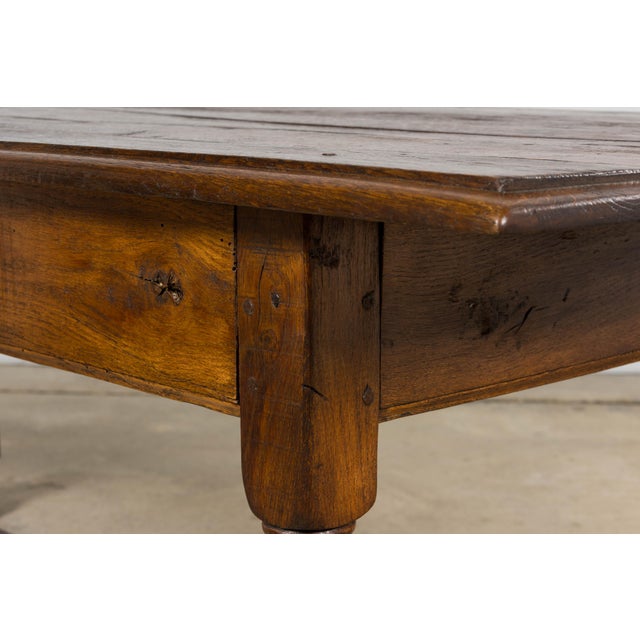 Sourced in Provence, France, this early 19th century French provincial oak farm table reflects the influence of Louis XIII...