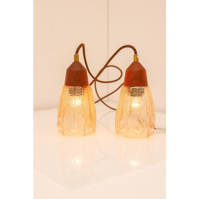 An unusual pair of mid-century pendant lamps by Pukeberg, combining elements of Art Deco elegance with Scandinavian modern...