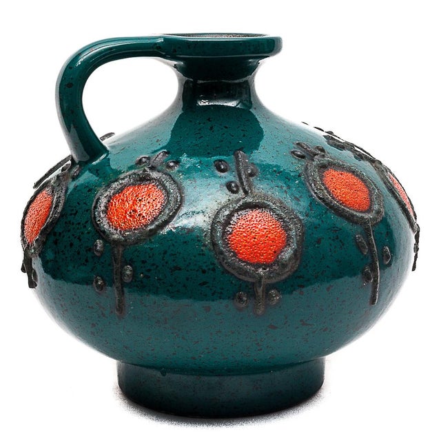 Vase with a blue-green handle and red medallions outlined in black lava. 4080 A Circa 1960 – East Germany I have official...