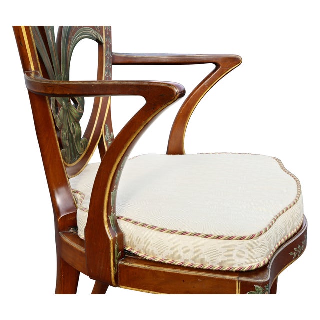 With shield back and painted Prince of Wales plume over a pair of arms, serpentine caned seat raised on tapered circular...