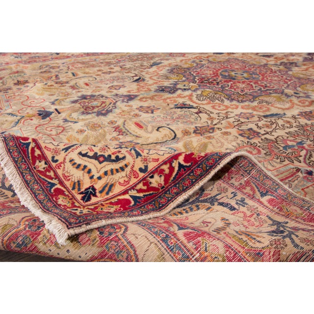 Beautiful vintage Persian Tabriz hand-knotted wool rug with a beige field. This piece has a multi-color accent in an all-...