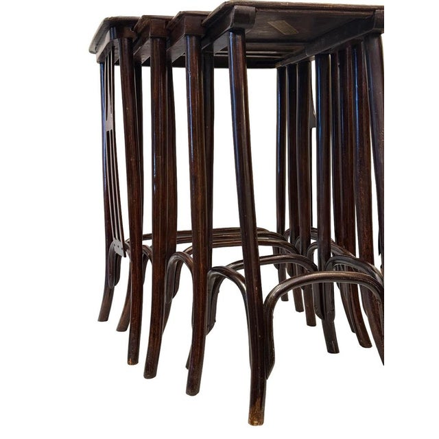 Elegant set of four Vienna Secession nesting tables produced by Jacob & Josef Kohn, Vienna, circa 1900. Crafted in steam-...