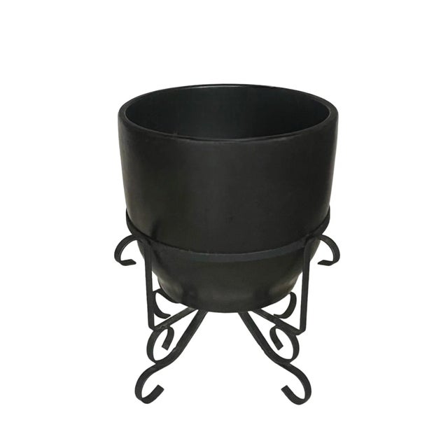 A perfect garden accent, this large Mid-Century planter in a satin black finish is fitted into a wrought iron stand....