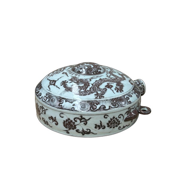 This striking ceramic moon flask, or bianhu, features a flattened globular body and a short, cylindrical neck flanked by...