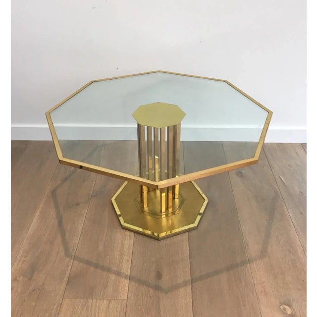This rare octagonal design coffee table is made of a beautiful brass base with an octagonal glass top. The glass is...