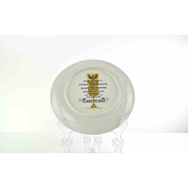 Carro Vinario is a silk-screened porcelain plate, designed by Piero Fornasetti for Martini & Rossi in 1960s . This piece...