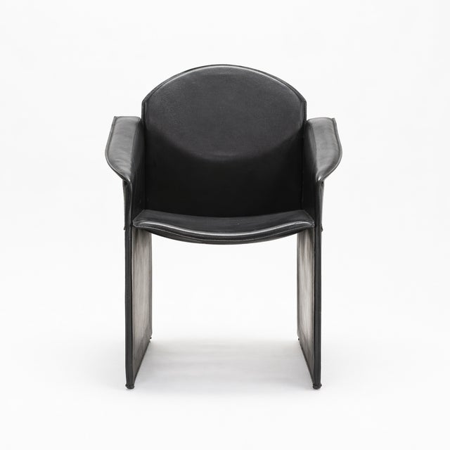 Black leather armchair with concealed hardware, postmodern design, from the 1970s, possibly Italian. Reminiscent of the...