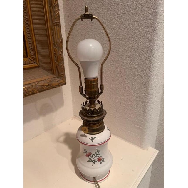 This piece is a classic vintage oil lamp that has been professionally converted to run on electricity. It features a...