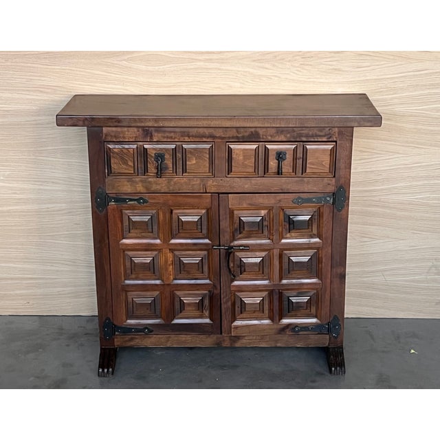 From Northern Spain, constructed of solid walnut, the rectangular top with molded edge atop a conforming case housing two...