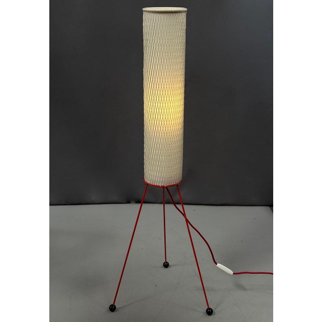 Mid-century “Rocket” floor lamp from the 1950s–60s. Cylindrical perforated shade, red tripod metal frame and soft diffused...