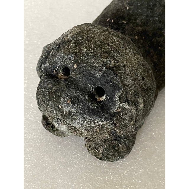 Vintage handmade concrete puppy dog playing figurine for garden decor.