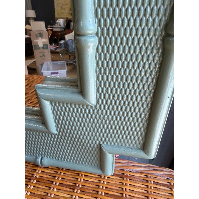 Charming vintage mirror with a soft sage-green finish, faux bamboo detailing, textured crosshatch panels, and decorative...