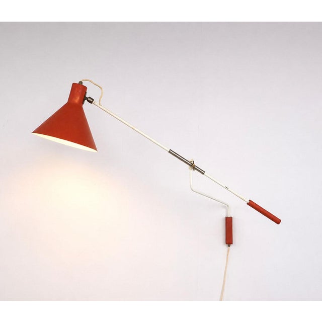 Vintage Anvia 7056 wall lamp, designed by J.J.M. Hoogervorst in the 1950s. This distinctive lamp features a counterbalance...