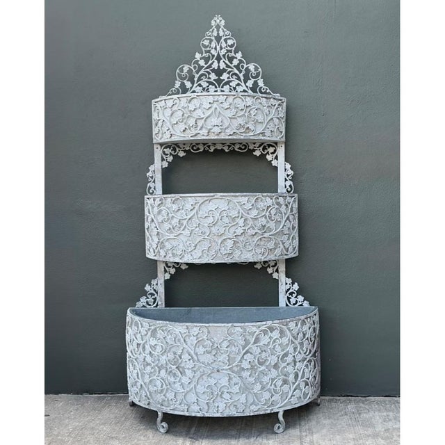 This monumental vintage tiered standing planter is a remarkable example of ornamental ironwork, combining wrought iron and...