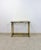 Add timeless elegance to your space with this vintage mid-century modern brass console table featuring a sleek glass top....