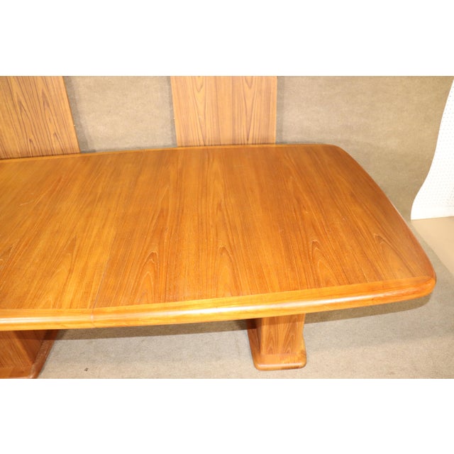 Mid-Century Modern dining table in teak wood grain. Danish made with two 21.75" leaves that create a table length of over...