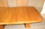 Mid-Century Modern dining table in teak wood grain. Danish made with two 21.75" leaves that create a table length of over...