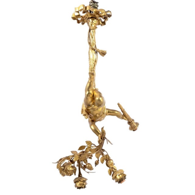 Louis XVI Style Gilt Bronze Cherub Three Light Pendant Lamp, early 20th century, a cherub suspended from ribbon ceiling...
