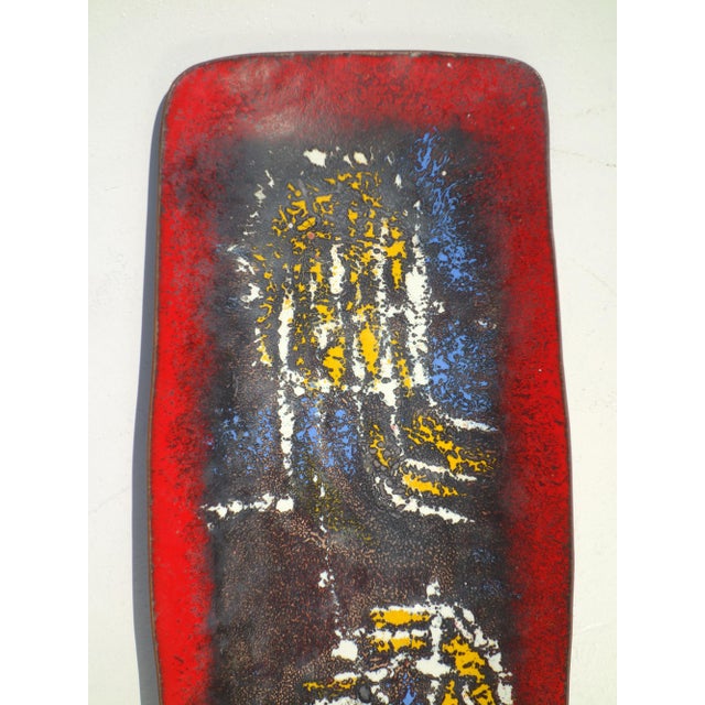 A striking example of mid-century modern decorative art, this elongated rectangular plate features a richly enameled...