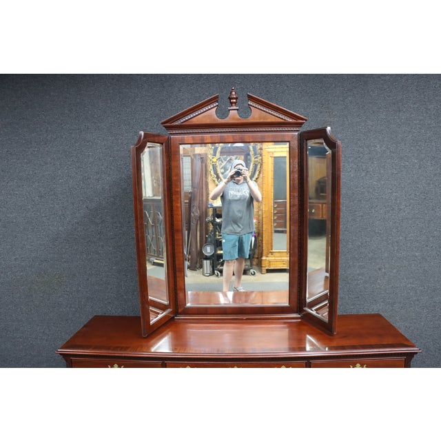 Thomasville mahogany dresser featuring a tri-fold mirror, brass hardware, and generous storage. This traditional-form...