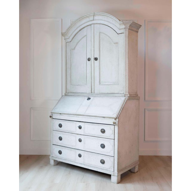 An elegant late 18th century Swedish Gustavian secretary cabinet, handcrafted in pine and finished in a softly distressed...