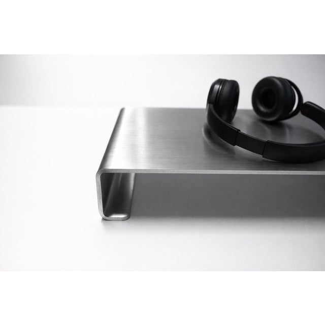 This sculptural monitor stand is designed and handmade by VELIENTO Studio in Poland. Formed from a single sheet of brushed...