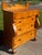 An exceptional and highly figured 19th-century American Empire chest of drawers that beautifully showcases a masterful...