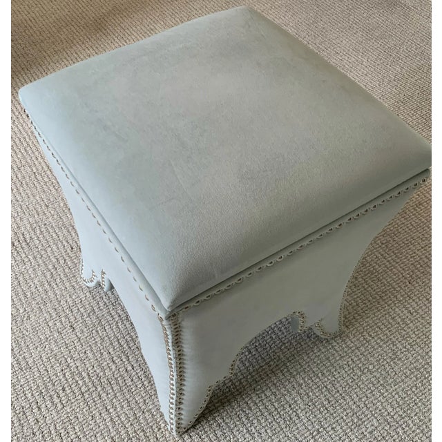 The chic storage ottoman recalls Moorish architecture with its cutout arch motif studded with silver nail heads....