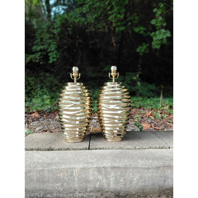 Authentic pair of Vaughan Bologna table lamps in the polished brass finish. Designed in England, these sculptural lamps...
