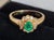 An elegant vintage british dress ring by ruk, crafted in solid 18-carat yellow gold and set with a central emerald...