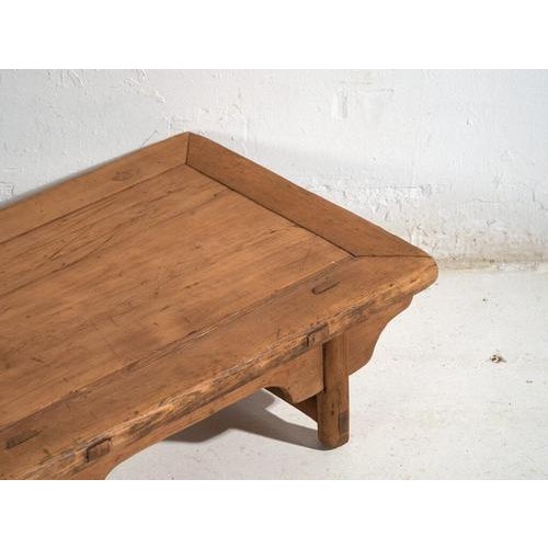 This antique Chinese kang-style low table, crafted in elm wood and dating to around 1900, belongs to the tradition of...