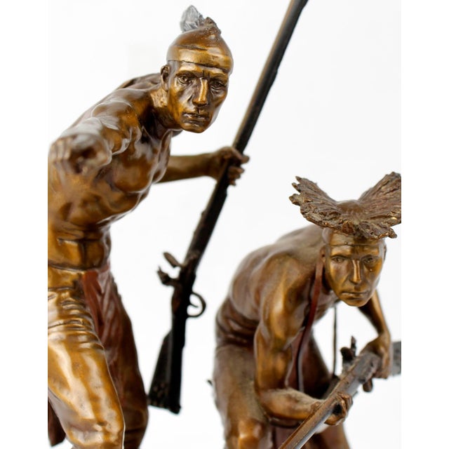 BRONZE SCULPTURE BY ERNIE CSELKO -'INTRUDER ALERT' Bronze sculpture depicting Native Americans. Plaque affixed to wood...