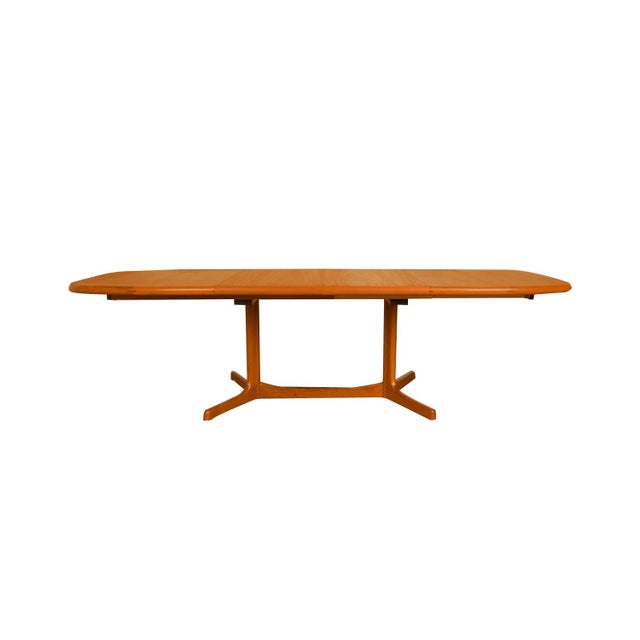 Beautiful Mid-Century Modern expandable dining table, circa 1970’s by Dyrlund. Featuring richly grained, gleaming teak and...