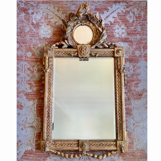 A fine Italian carved pine mirror with a carved and gilded gesso surface, dating to the early 19th century. The design has...