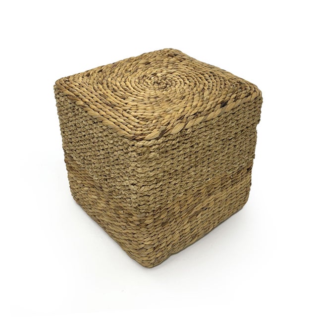 The Woven Ottoman from Zentique is a handwoven cylinder ottoman in light brown water hyacinth and corn husk leaf. The...