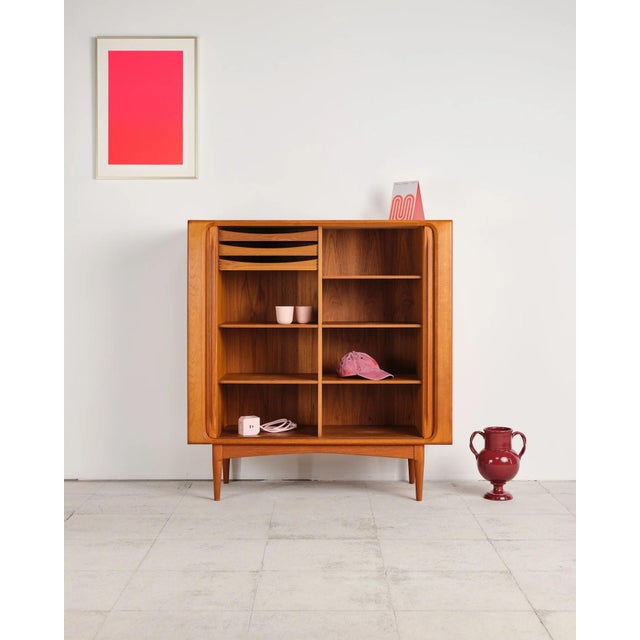 Dimensions: approx. 120 × 48 × 128 cm (width × depth × height) An exceptionally high-quality teak highboard, crafted by...