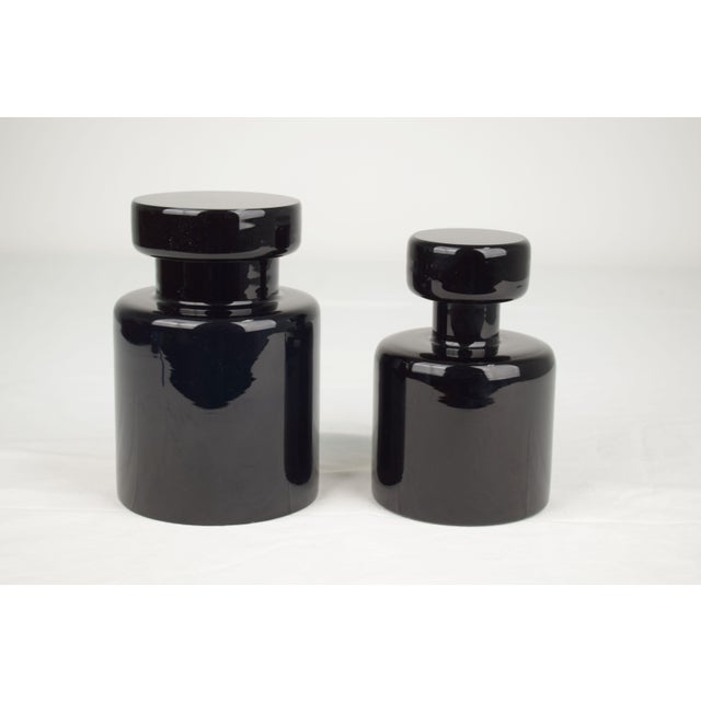 A set of two Murano glass bottles produced by Vistosi in the 1970s, a refined example of Italian design from the period....